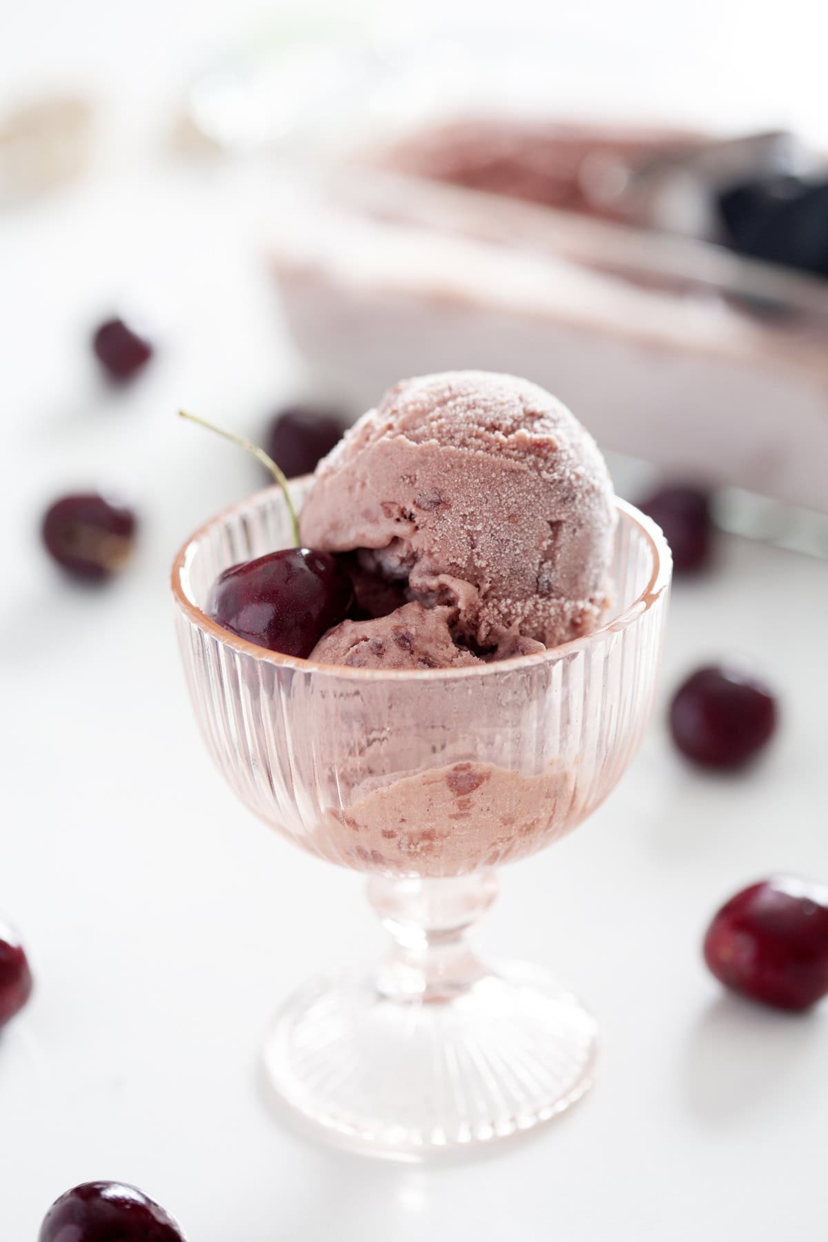 pink glass cup of AIP cherry ice cream with black cherry