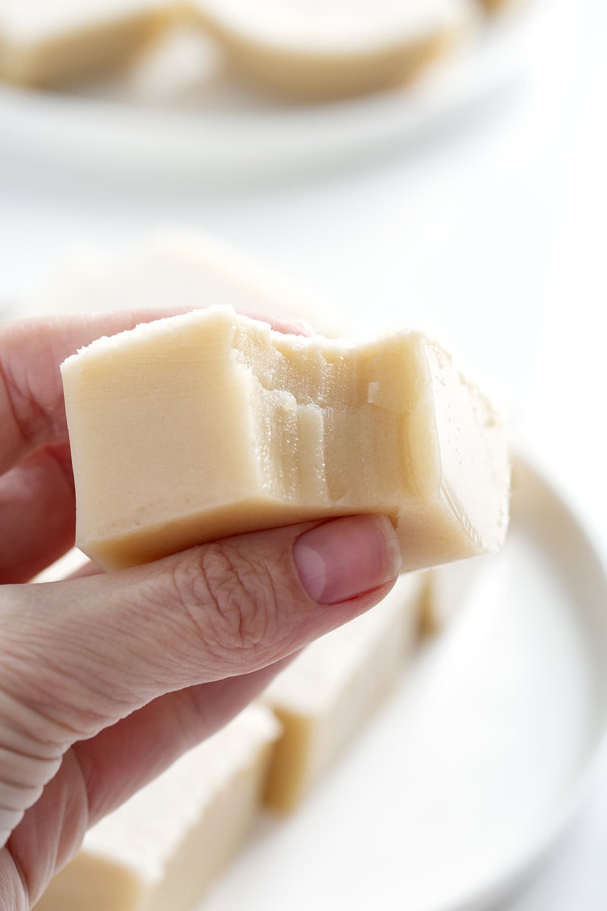 hand holding piece of Chinese coconut pudding
