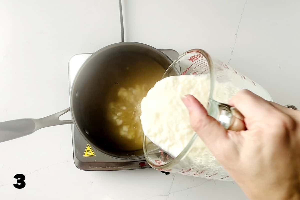 pouring gelatin and milk mixture into saucepan