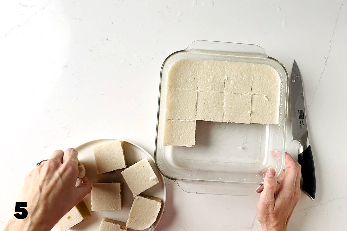 placing Chinese coconut pudding squares onto plate