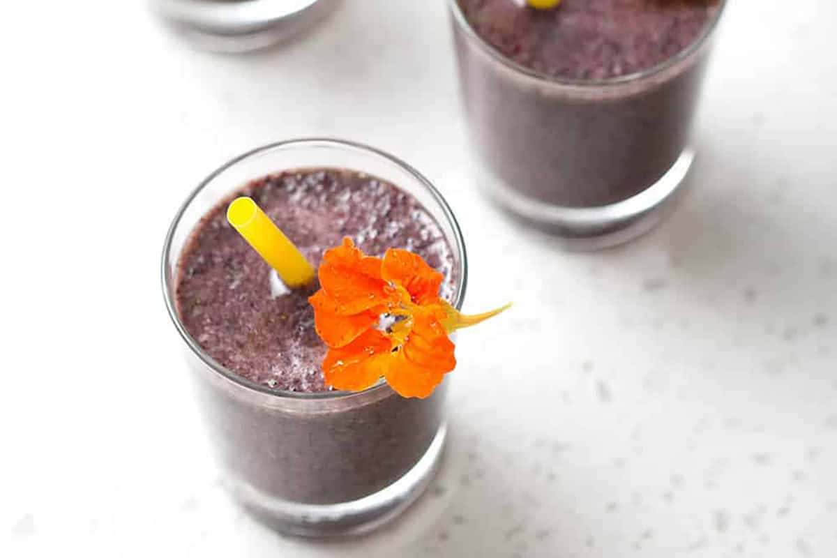close up of smoothie with flower and straw